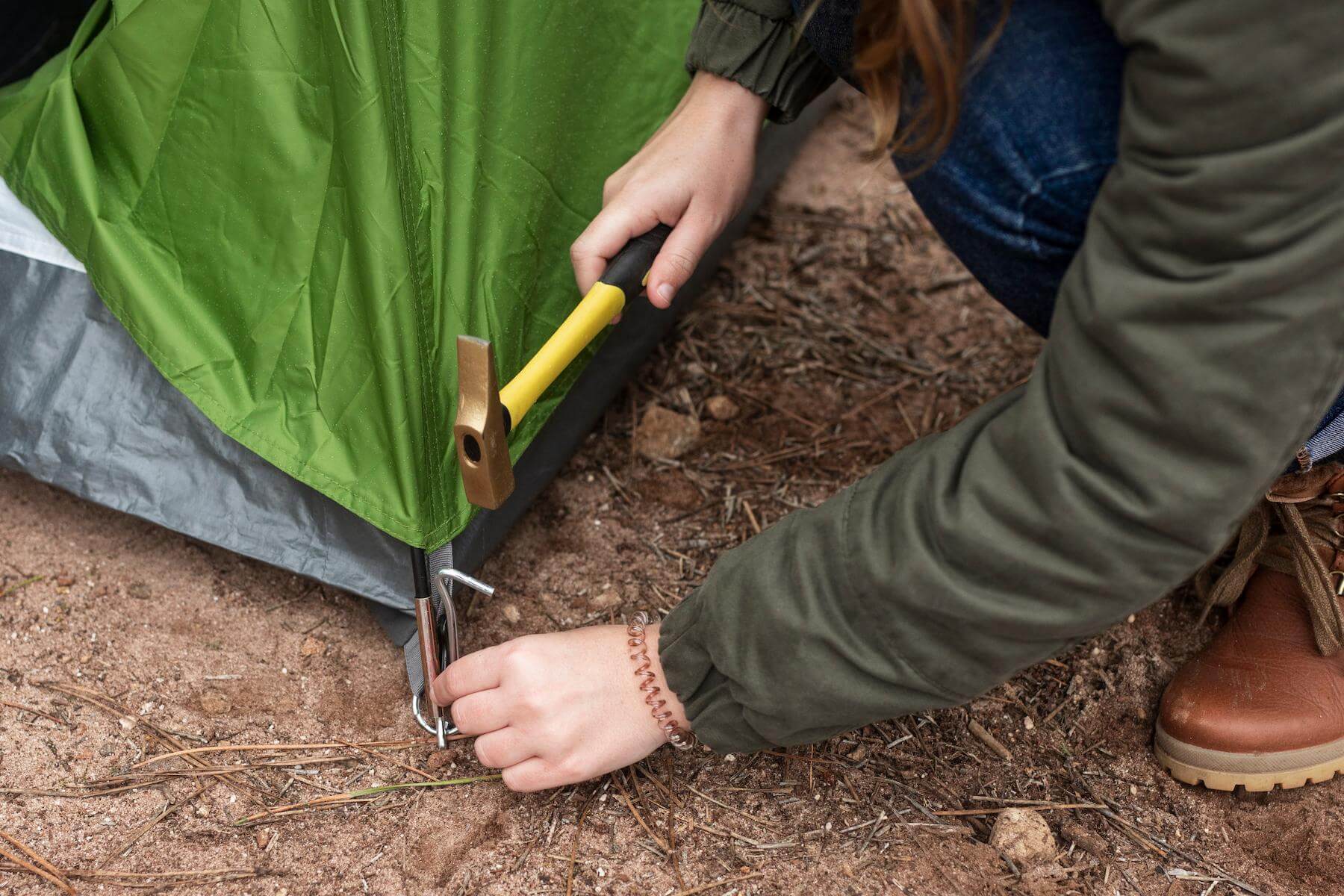 A metal tent peg in the ground.