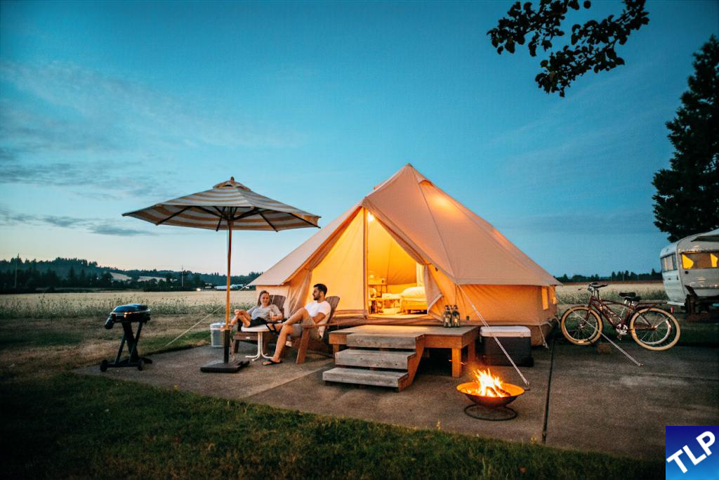 A well-organised campsite with various pieces of camping gear laid out.